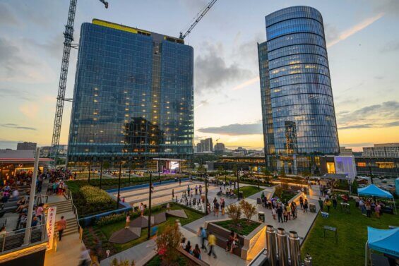 A courtyard at Capital One Center in Tysons, Virginia teems with people at dusk.