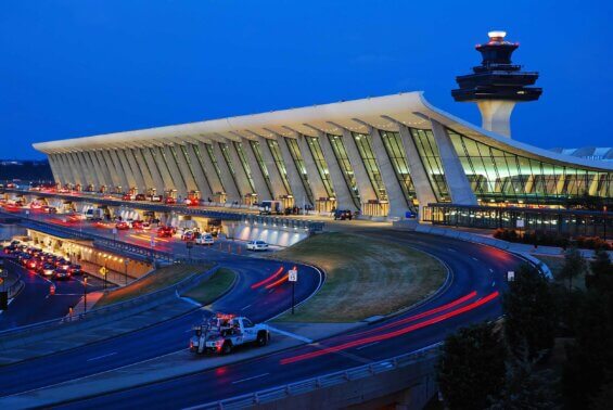 The exterior of Dulles International Airport at nightfall.