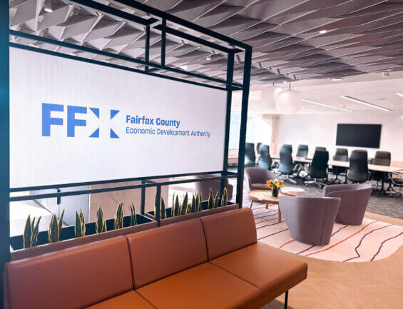 The interior of the FCEDA office building, with a sign reading "FFX", lounge chairs, and a boardroom table with high-back chairs.