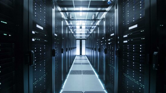 An empty corridor in a data center, with server cabinets lining either side.